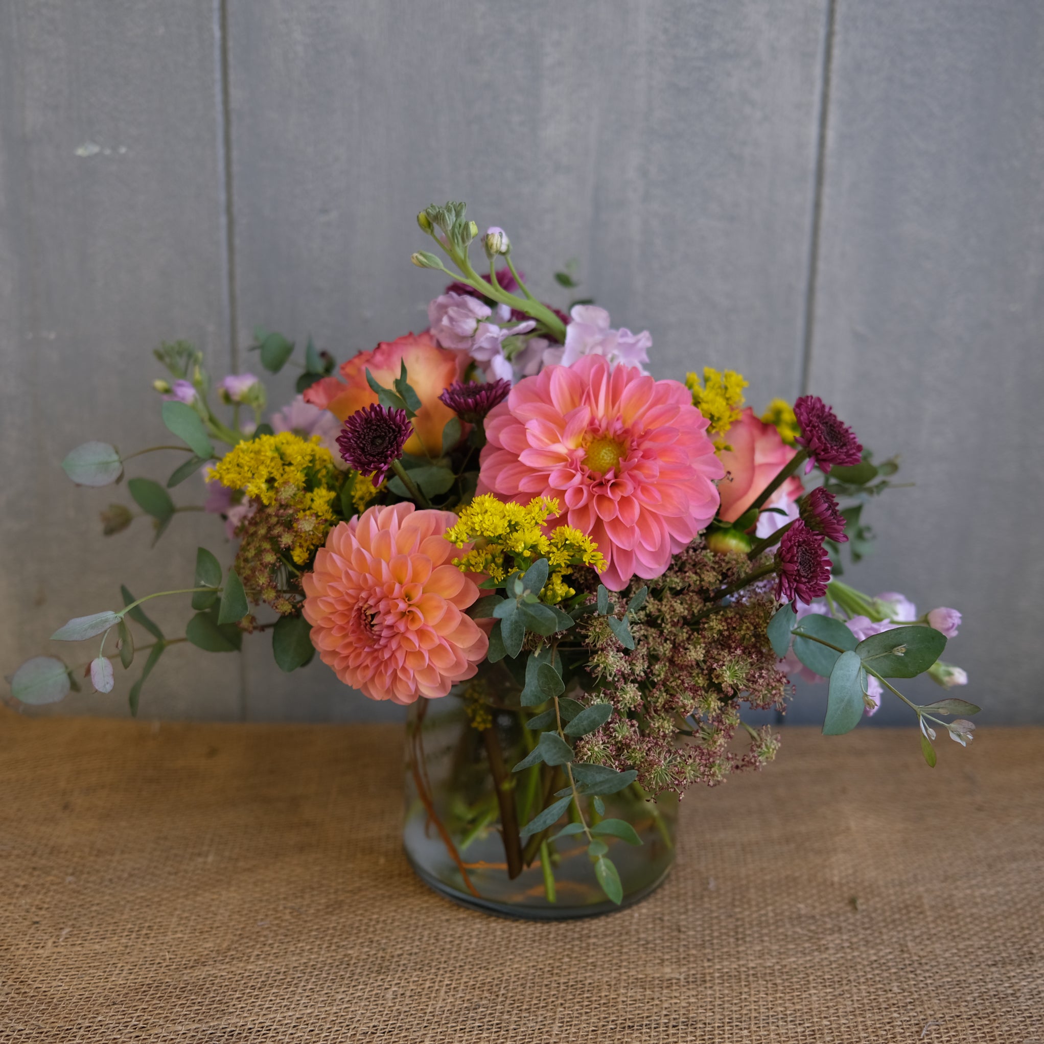 floral arrangement with peach dahlia, lavender stock, and eucalyptus 