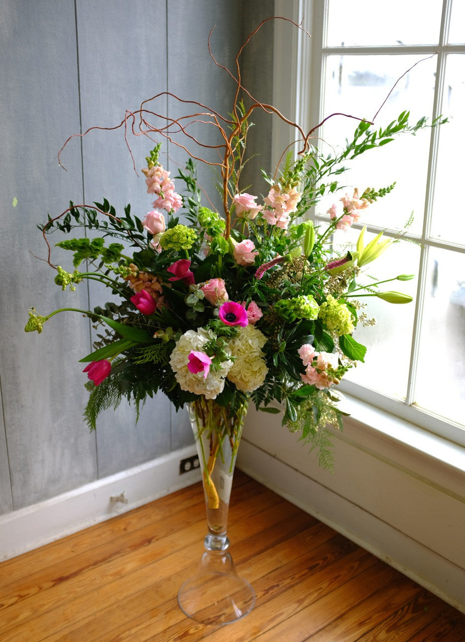 Amsterdam: Tall Martini Glass Floral Arrangement with Anemones, Roses, Snapdragons and Willow. Designed by Michler's Florist in Lexington, KY