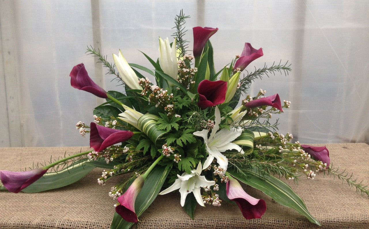 Edinborough: Funeral Flowers with Purple Calla Lilies and White Lilies. Designed by Michler's Florist in Lexington, KY