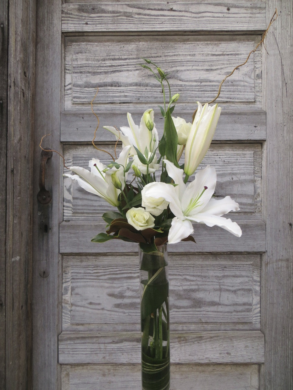 Limestone Flower Arrangement: Tall vase with white lilies and lisianthus. Designed by Michler's Florist in Lexington, KY