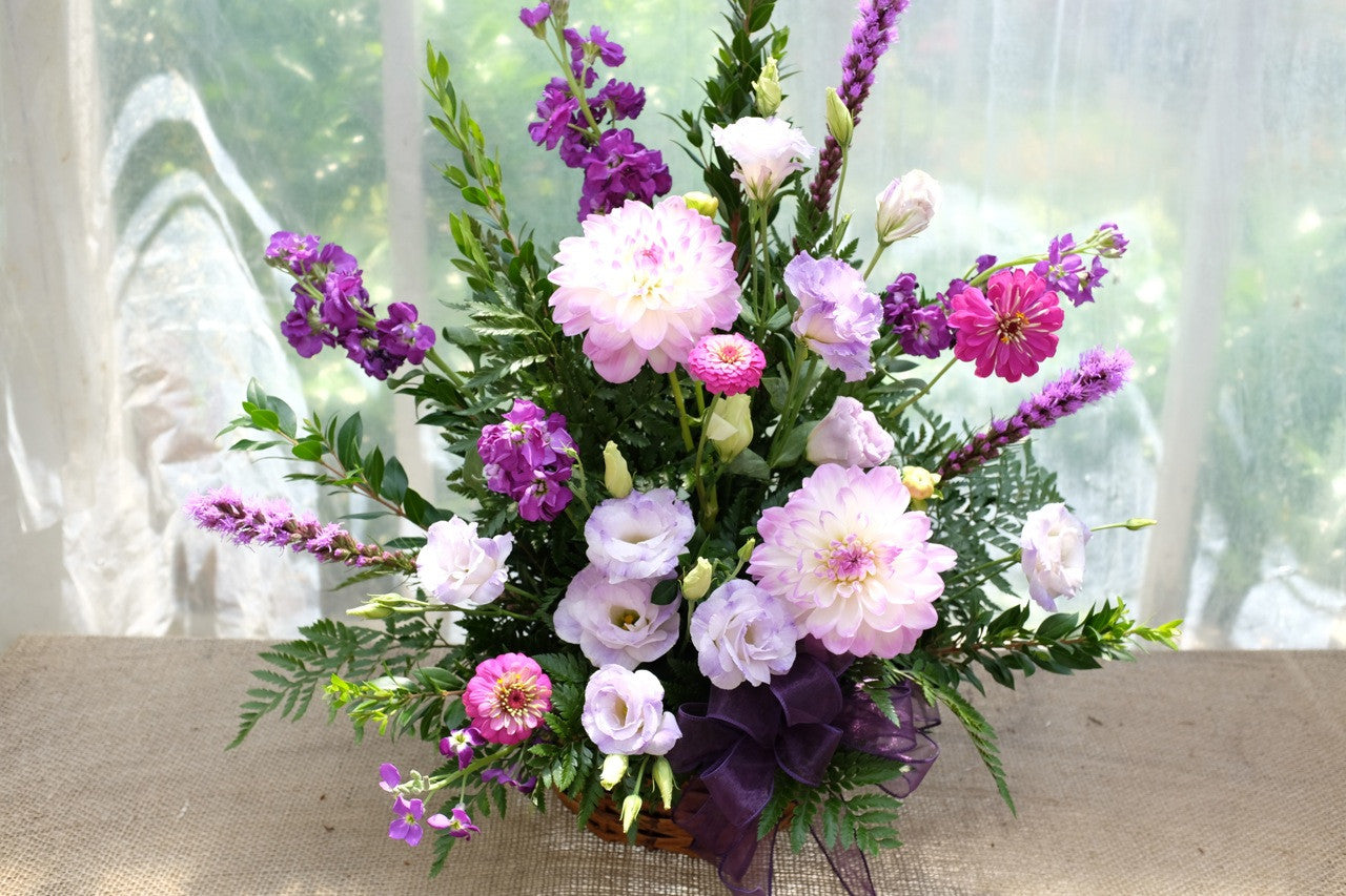 Funeral Basket with lavender Lisianthus, Light pink Dahlias, Liatris, and Stock. | Michler's Florist