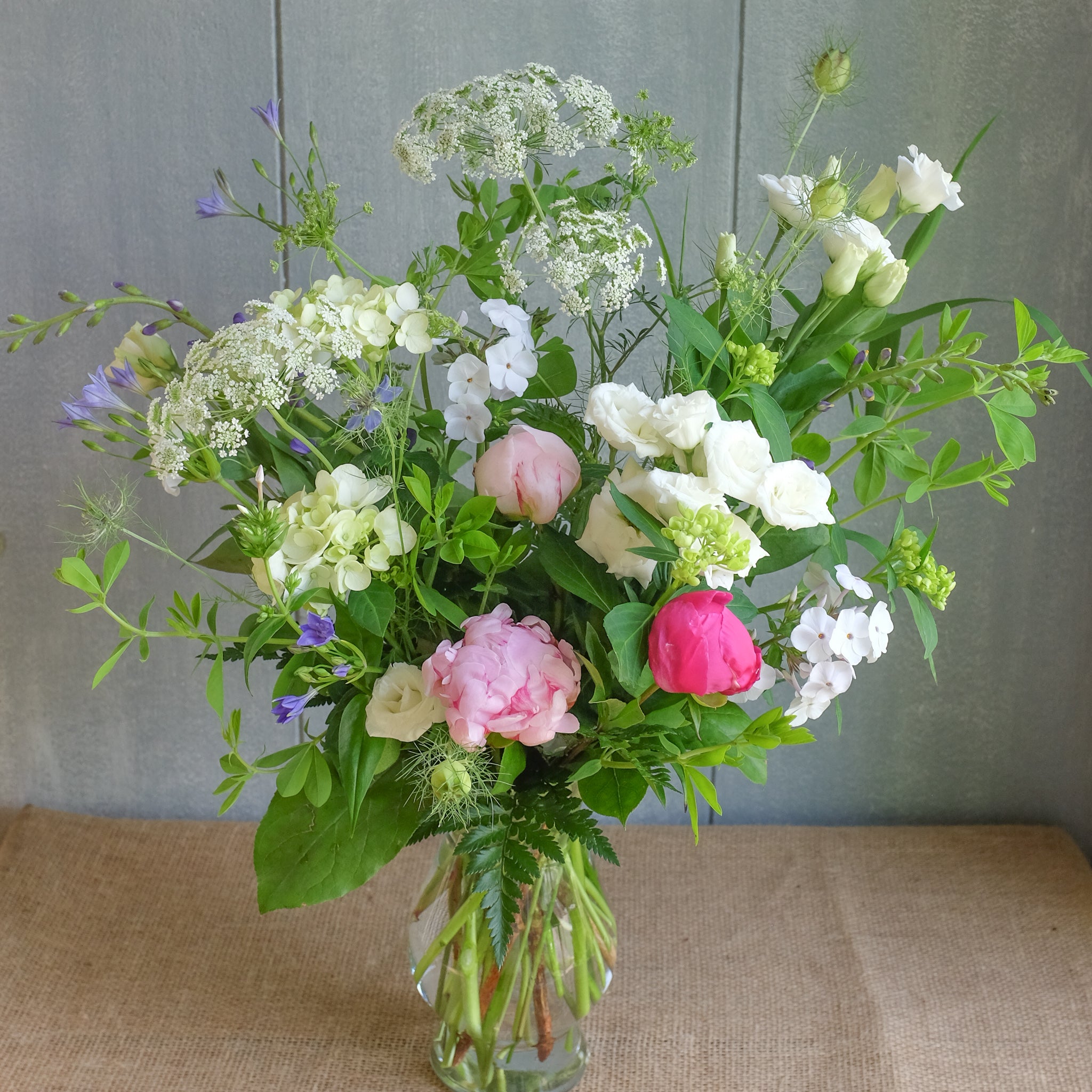 Field bouquet with peonies and baptesia.