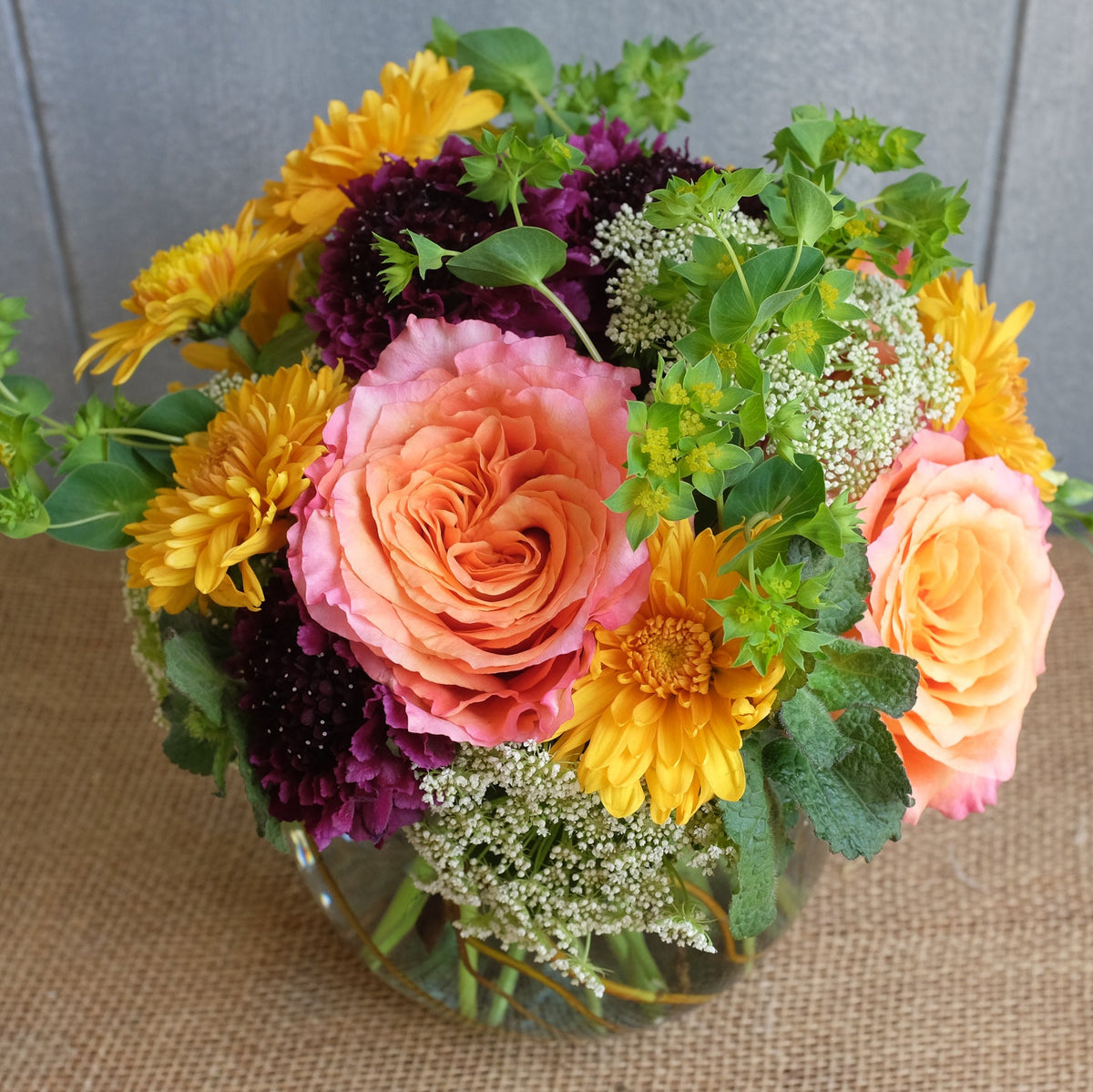 Lush composition of flowers in a vase designed by Michler Florist.