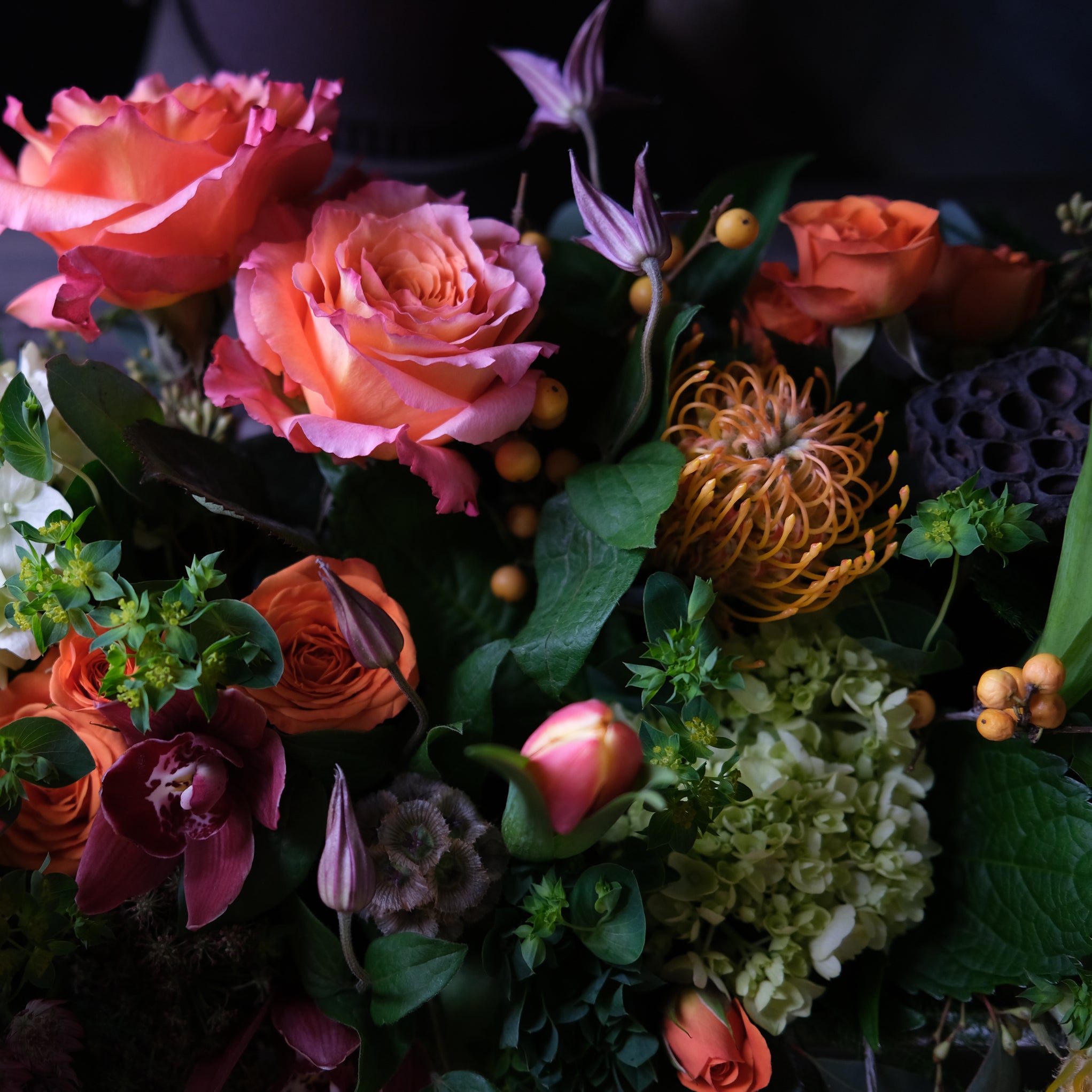 pink and orange roses, tulips, orchids, lotus pods, and hydrangea