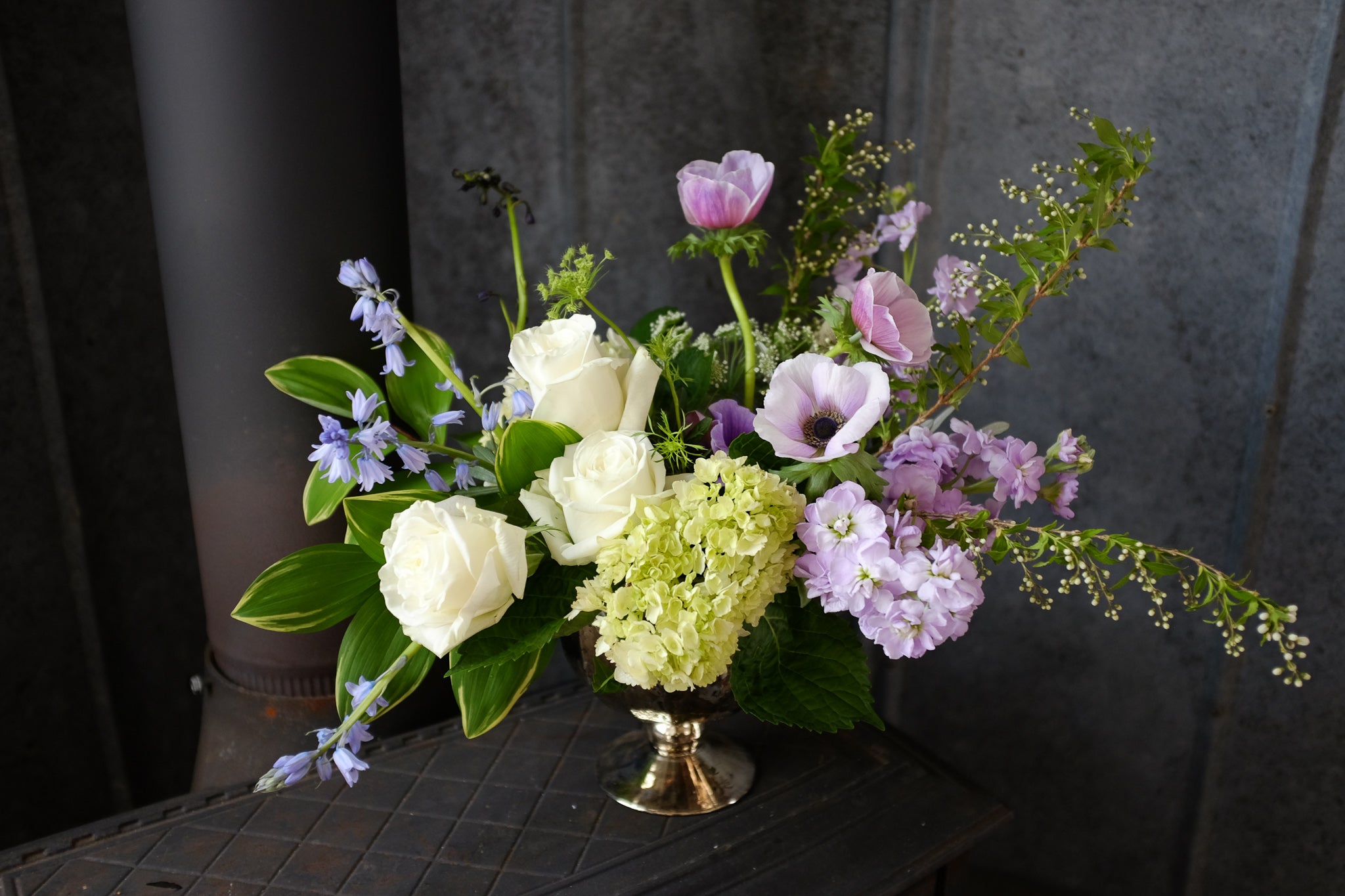 Alcott Flower Design iwth Solomon Seal, Spanish Blue Bells and Anemones by Michler's Florist