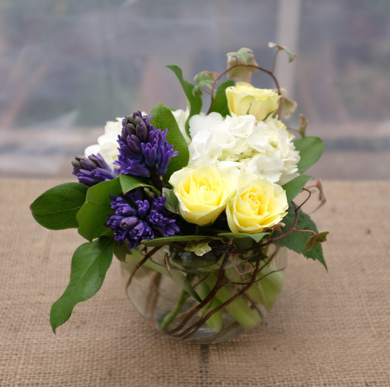 Andover Flower Arrangement: Yellow Sweetheart Roses, Hydrangea, Blue Hyacinth, and Ivy Vines.  Designed by Michler's Florist in Lexington, KY