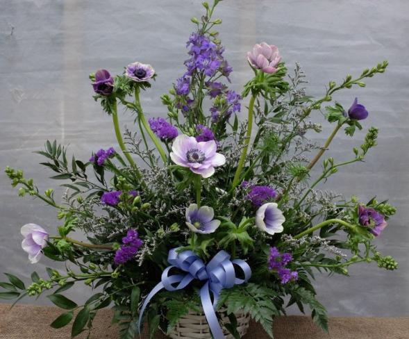 Funeral Basket with blue and lavender flowers including Anemones.  Designed by Michler's Florist in Lexington, KY