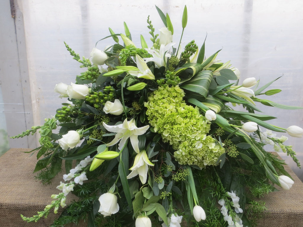 Casket Spray with Green Hydrangea, White Lilies, Roses, and Tulips. Michler's Florist