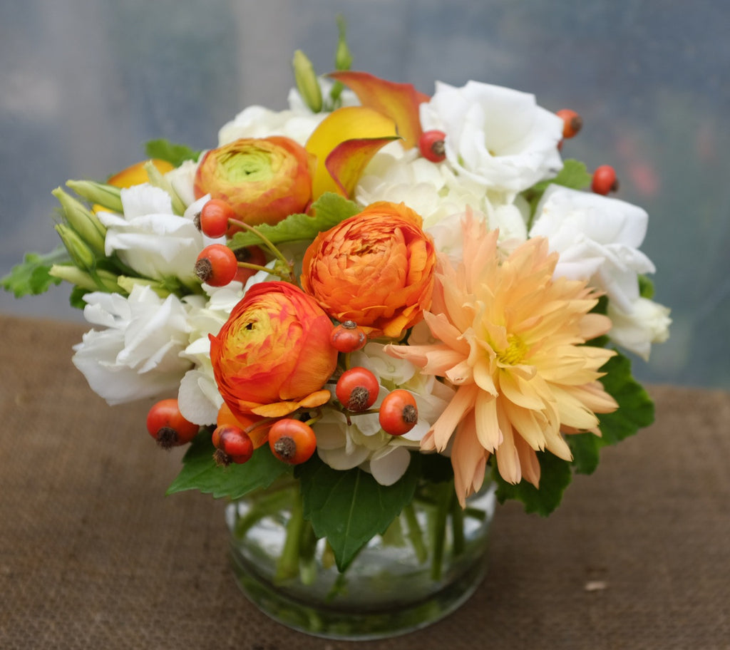 Bellcastle: Flower design with orange Dahlia, Ranunculus, Calla Lilies and White Lisianthus | Michler's Florist 
