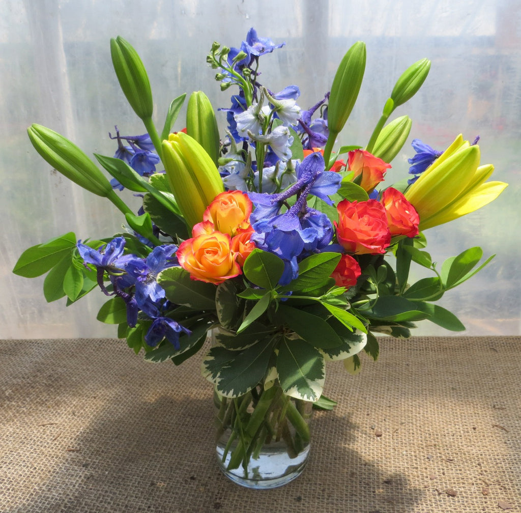 Bellefonte Flower Arrangement: Yellow Lilies, Blue Delphium, and Orange Roses.  Designed by Michler's Florist in Lexington, KY