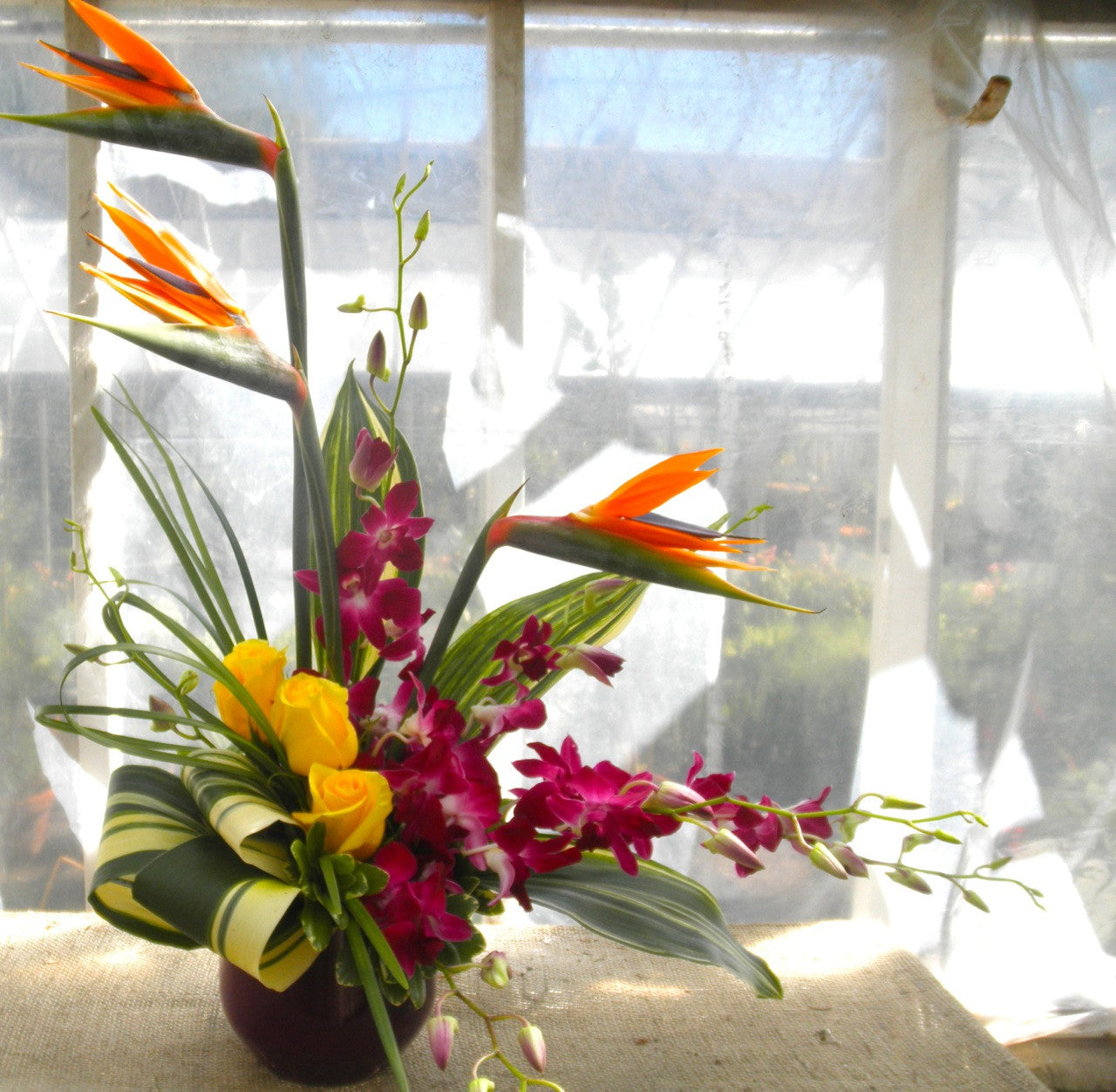 Floral arrangment by Michler's Florist with birds of paradise and orchids