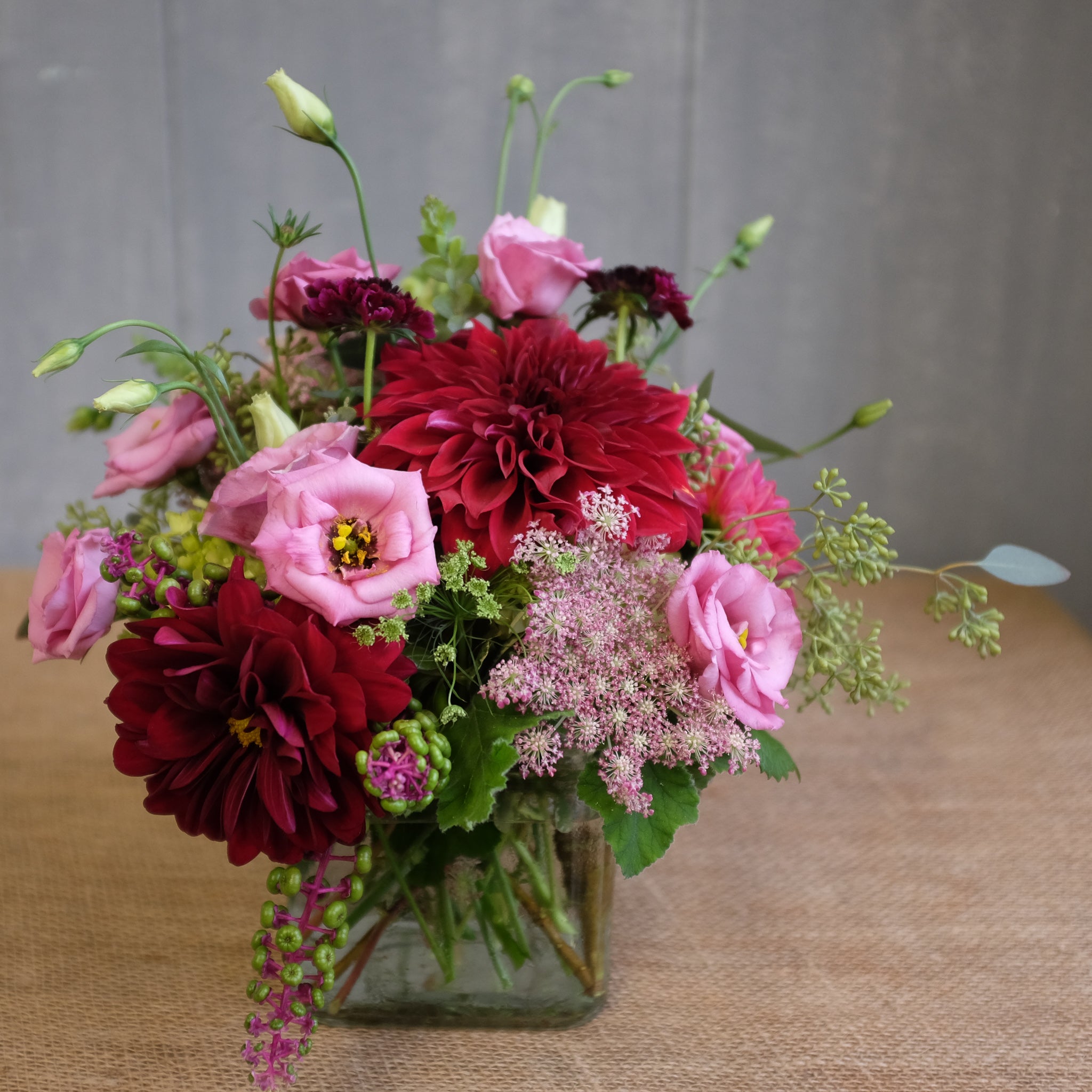low and lush flower arrangement with reds and pinks by Michler's