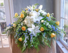 floral casket spray with roses, hydrangea, lilies, and stock by Michler's