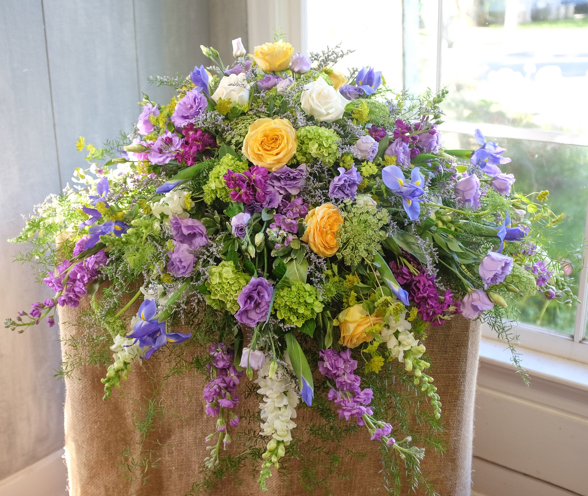 floral spray with hydrangea, roses, larkspur, and stock by Michler's