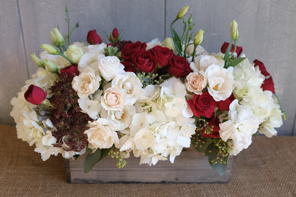 floral arrangement with hydrangea, Queen Anne's lace, and roses in a wooden box by Michler's