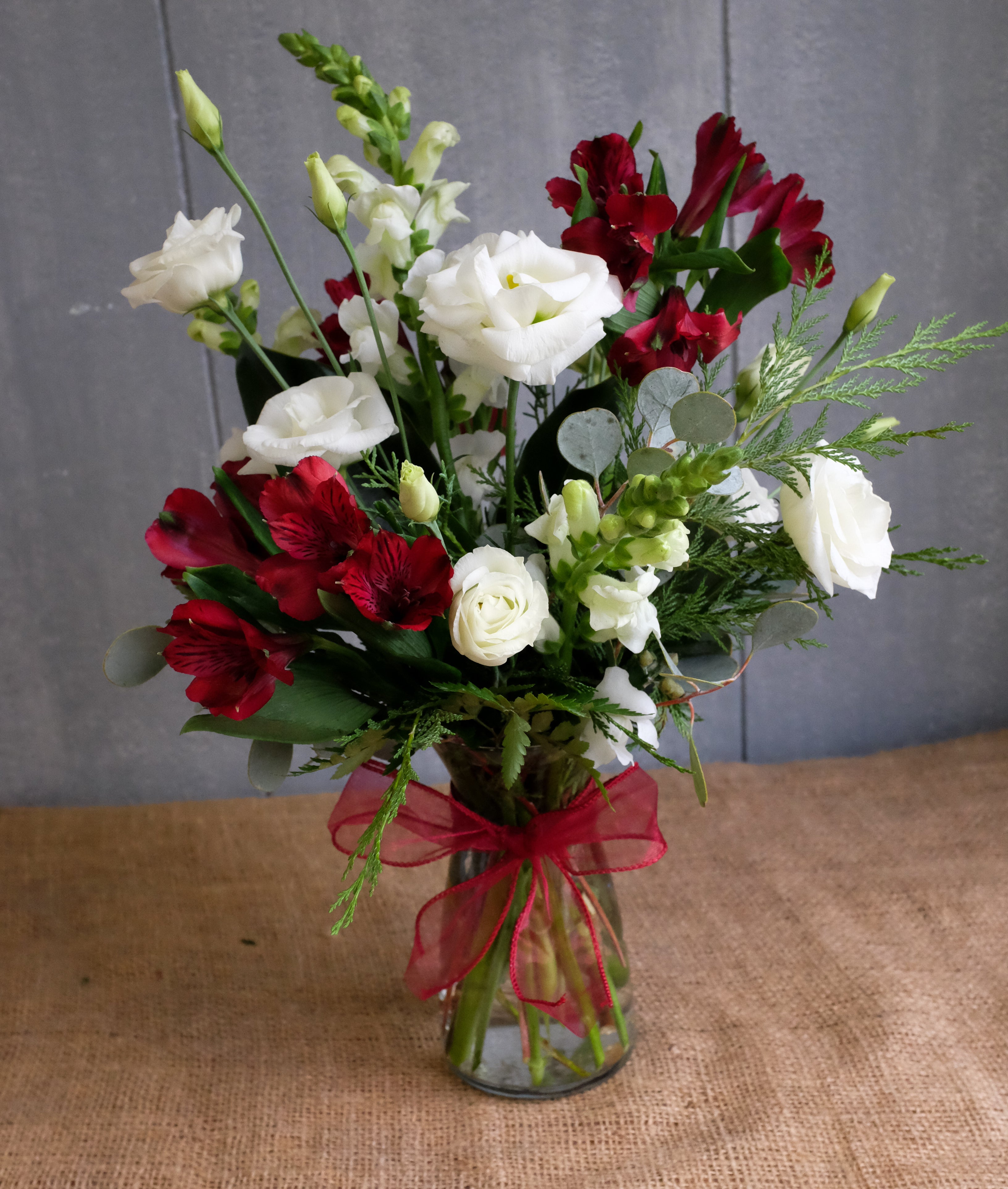 Chauncey Floral Arrangement: Designed with white Lisianthus, and red Alstromeria by Michler's Florist in Lexington, KY 