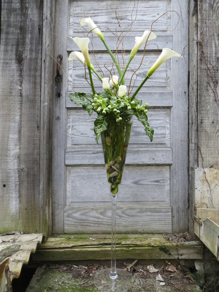 Chelsea Flower Design: Tall Champaign Flute with Calla Lilies, Roses and Hellebore