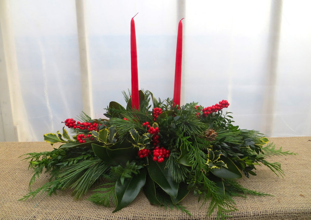 Christmas Centerpiece with Red Candles, Magnolia, and Holly Berries | Michler's Florist