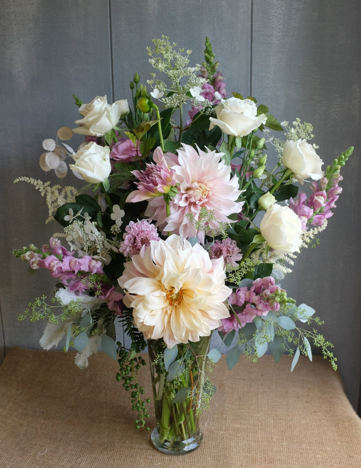 Floral arrangement with dahlias, astilbe, white roses, pink snapdragon by Michler's Florist