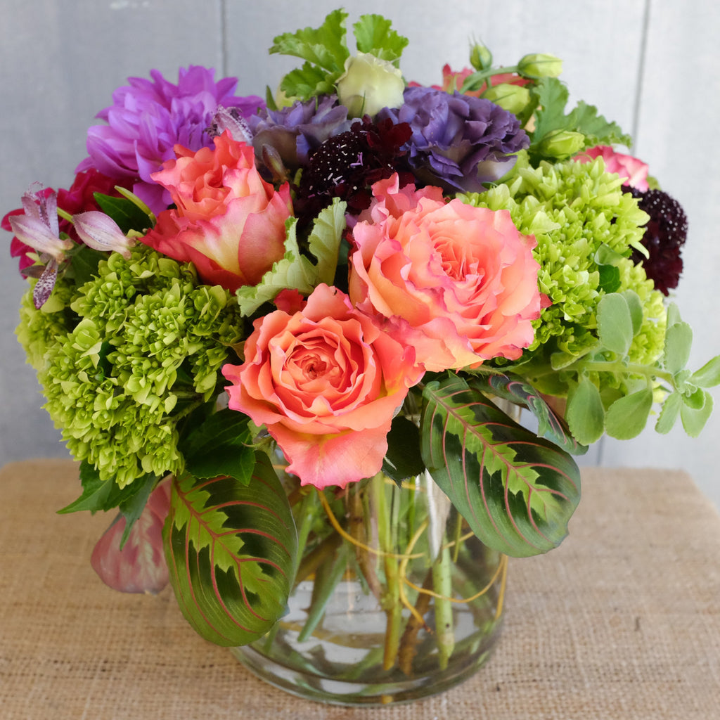 Hanningfield Flower Arrangement: designed with orange roses, green hydrangea, and purple scabiosa.  Designed by Michler's Florist in Lexington, KY