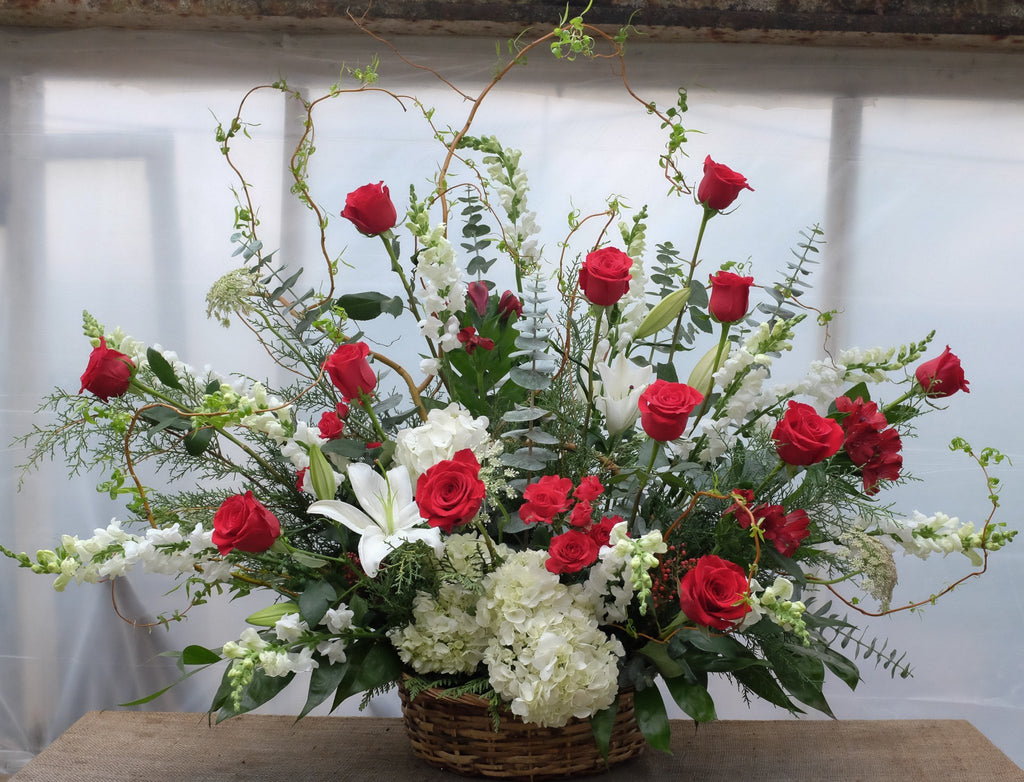 Floral arrangment with red roses, white snapdragons, white lilies, white hygrangea by Michler's Florist