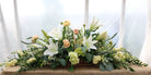 Funeral Floral basket with white lilies, peach ranunculous by Michler's Florist
