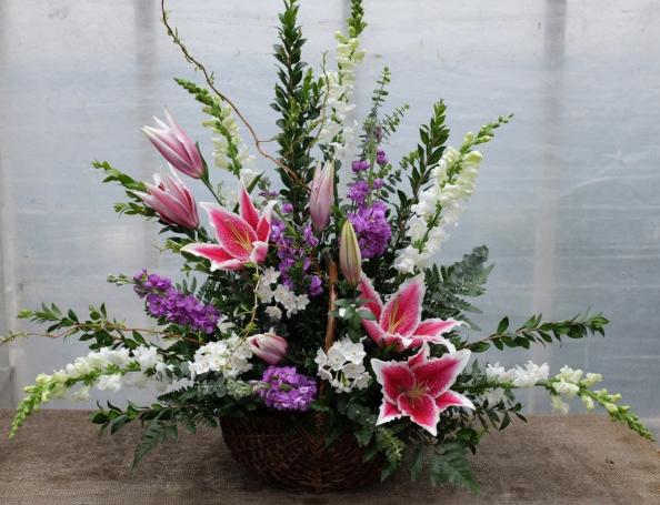 Eldemere Funeral Basket with White Snap Dragons, Stargazer Lilies, and Purple Stock. Designed by Michler's Florist in Lexington, KY