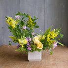 Naturalistic bouquet of yellow flowers with a touch of pink