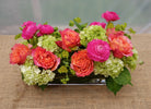 Evora: Floral centerpiece with Ranunculus, Roses, and Hydrangea | Michler's Florist