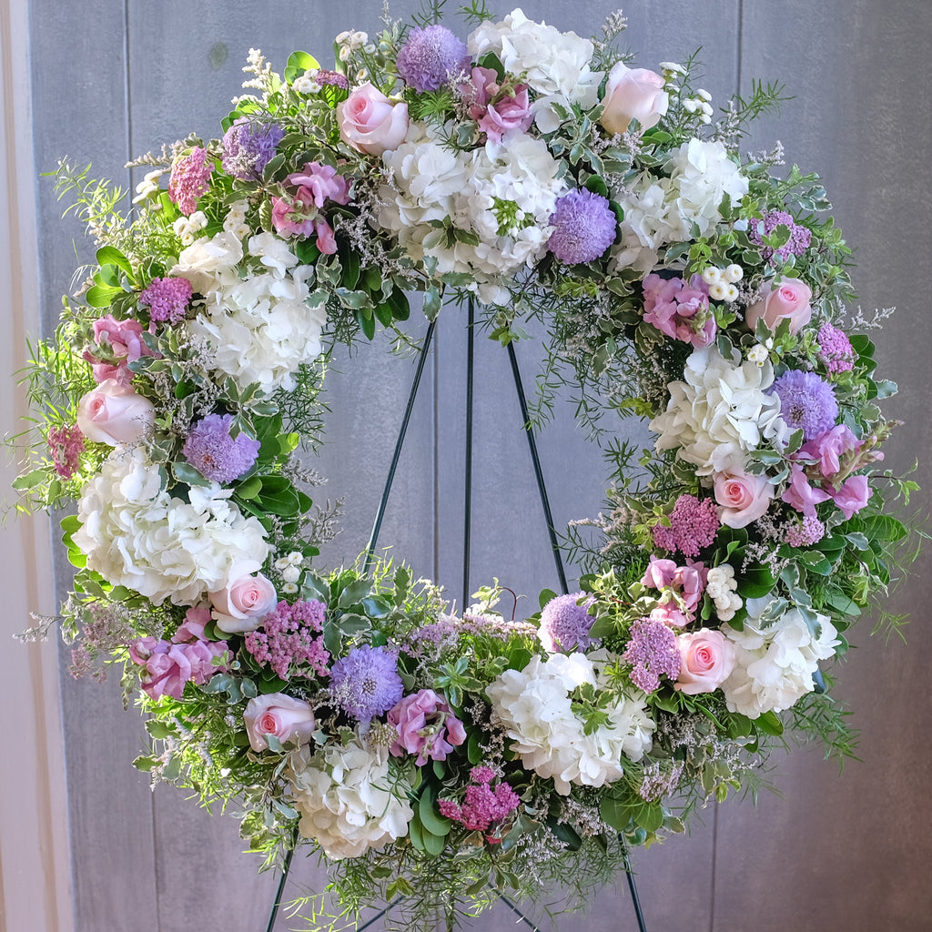 floral sympathy wreath with hydrangea, roses, stock, and accents by Michler's