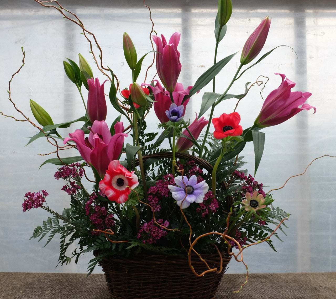 Granard Funeral Basket with Lilies and Anemones. Designed by Michler's Florist in Lexington, KY