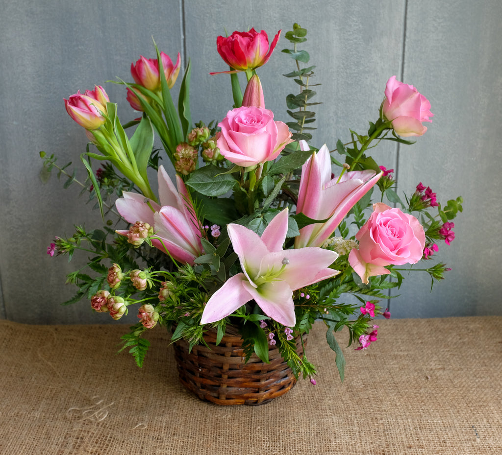 Wicker basket flower design with lilies, roses and tulips by Michler's Florist