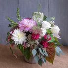 low and lush flower arrangement with roses, chrysanthemums, stock, and Queen Anne's lace by Michler's