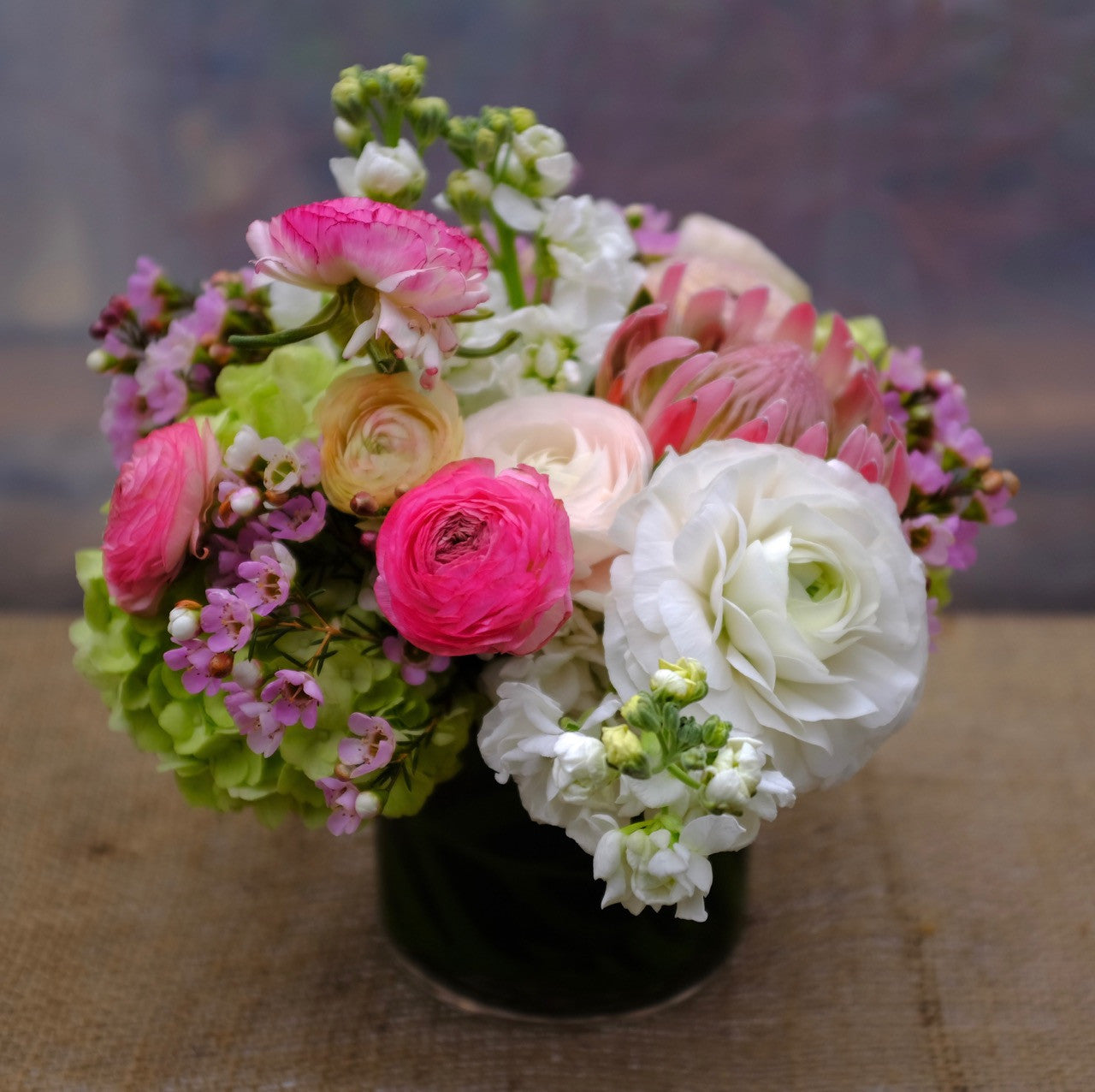 Juneau Bouquet with pink and white Ranunculus and Protea. Designed by Michler's Florist in Lexington, KY 