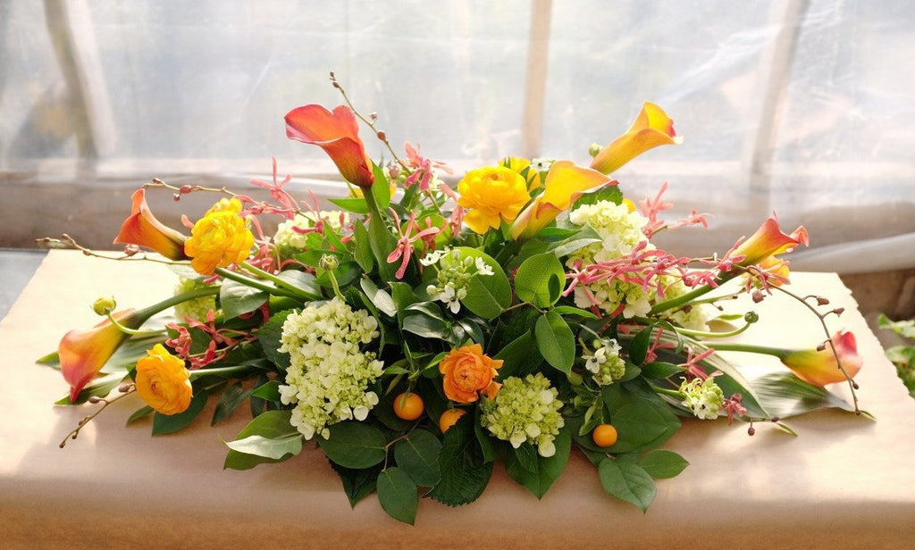 Kensington: Thanksgiving Centerpiece with Orange Calla Lilies, Ranunculus, Hydrangea and Aranthera Orchids | Michler's Florist