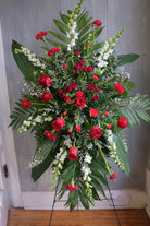 a floral easel spray with roses, carnations, stock, and limonium by Michler's Florist in Lexington, KY