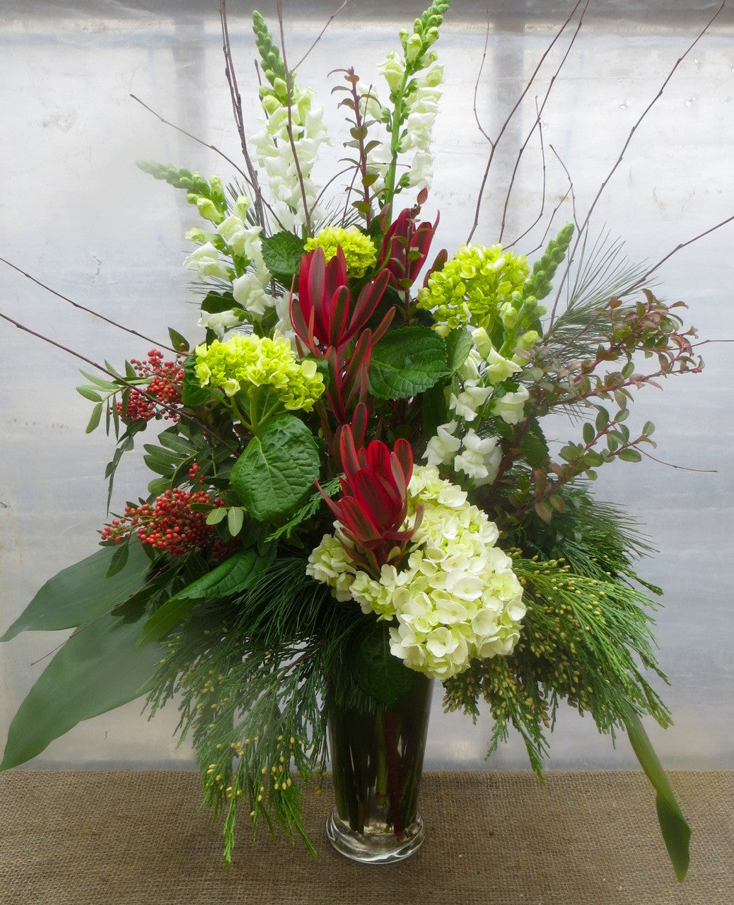 Kingswood: Floral Vase Arrangement with Evergreens, Pepperberries, and Hydrangea. Designed by Michler's Florist in Lexington, Ky