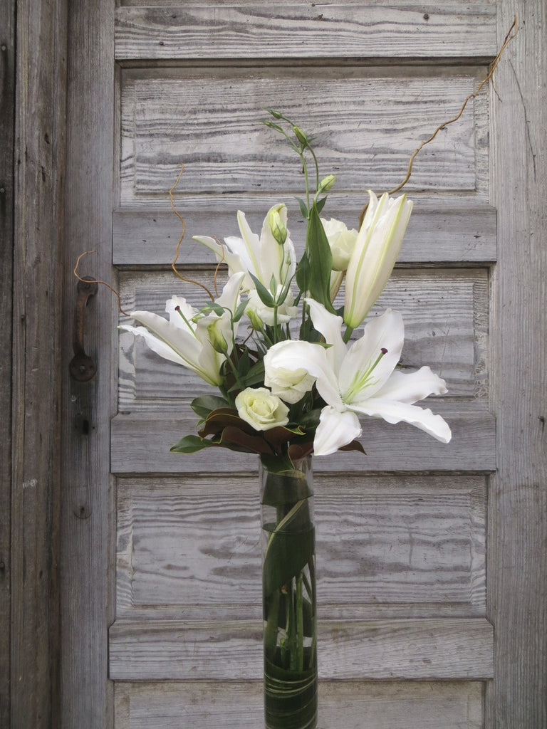 Limestone Flower Arrangement: Tall vase with white lilies and lisianthus. Designed by Michler's Florist in Lexington, KY 
