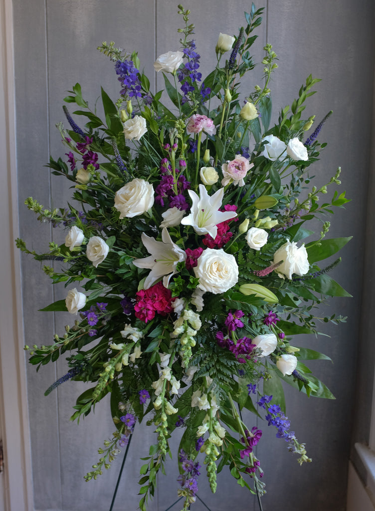 Standing spray in white and feminine jewel tones
