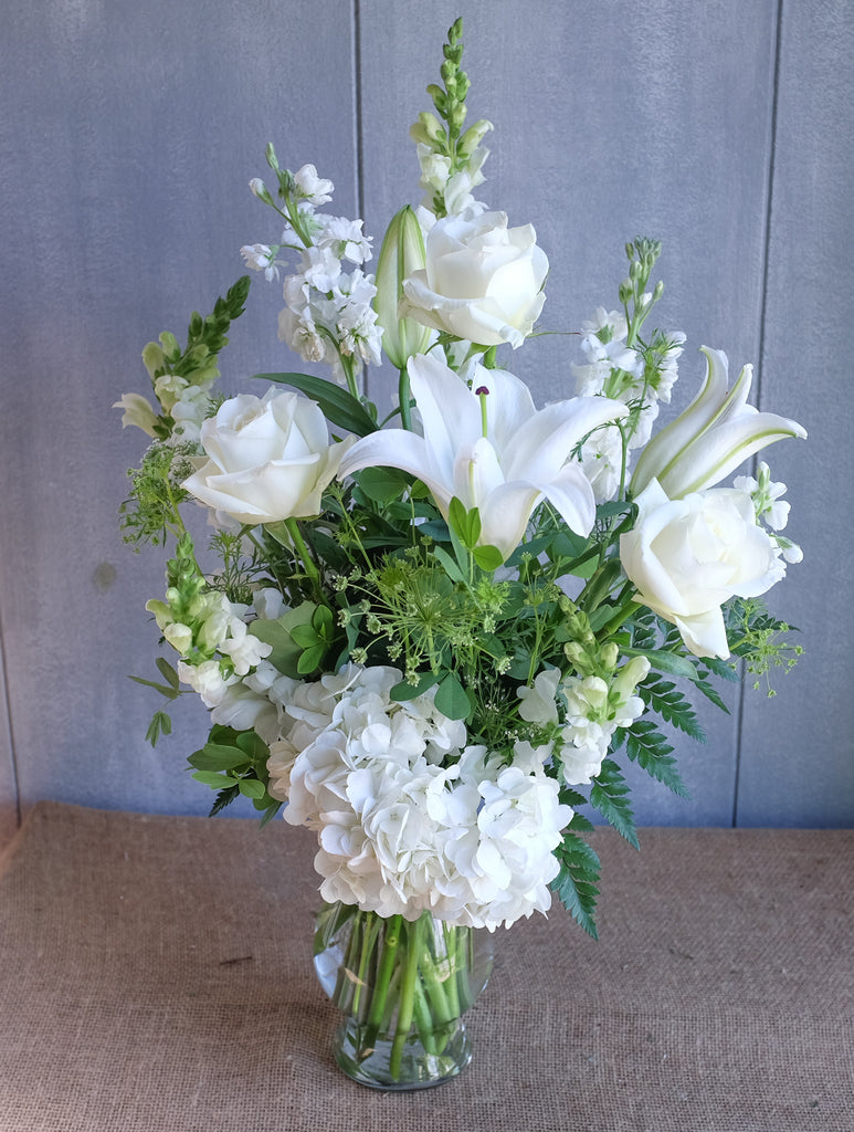 tall and elegant flower arrangement with white lilies, hydrangea, and stock by Michler's