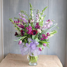 a tall and elegant bouquet with tulips, stock, and eucalyptus by Michler's Florist in Lexington, KY