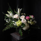 elegant floral design with lilies, ranunculus, eucalyptus, and stock by Michler's