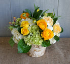 Bouquet of Yellow Ranunculus, Hydrangea, Roses and seasonal foliage.