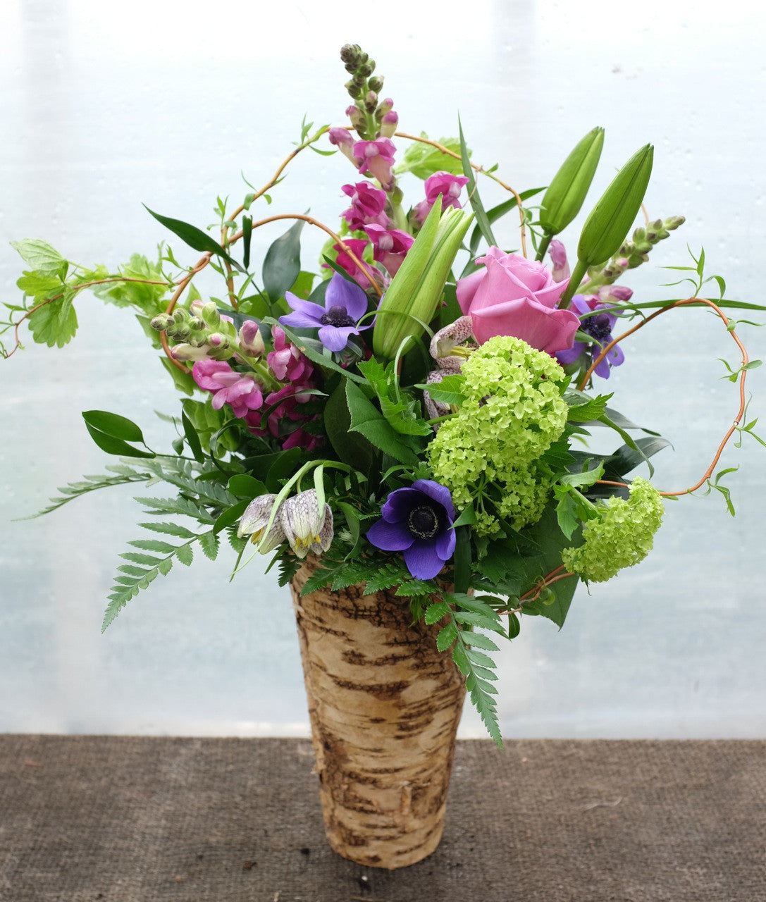 Avon: Spring Flower Bouquet with Viburnum, Fritillaria, Anemones, Snap Dragons in a Zinc lined Birch Pot.  Arranged by Michler's Florsit in Lexington, KY