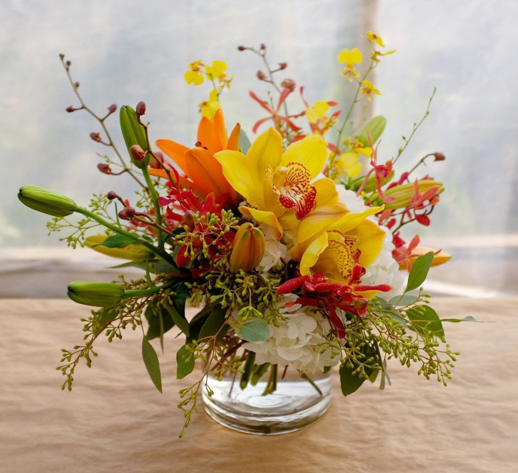 Pacific: Thanksgiving centerpiece design with Cimbidium and Oncidium Orchids. Michler's Florist in Lexington, KY