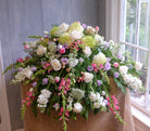 floral casket spray with roses, lisianthus, hydrangea, and stock by Michler's Florist in Lexington, KY