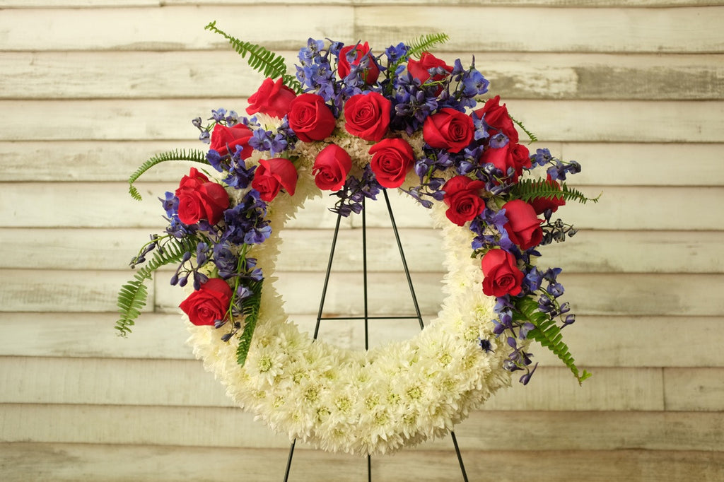 Patriotic Funeral Wreath with White Cusion Mums, Red Roses and Blue Delphinium