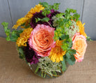 Lush composition of flowers in a vase designed by Michler Florist.