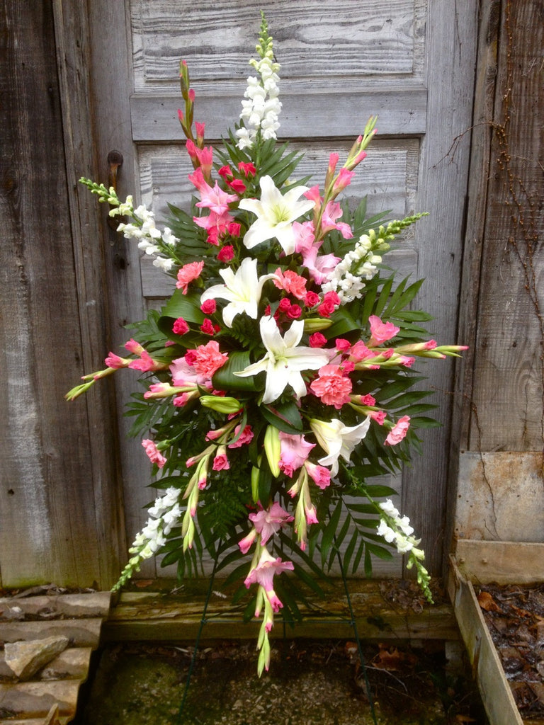 Pink and white funeral standing spray with pink Gladiolas and white Lilies. Designed by Michler's Florist in Lexington, KY
