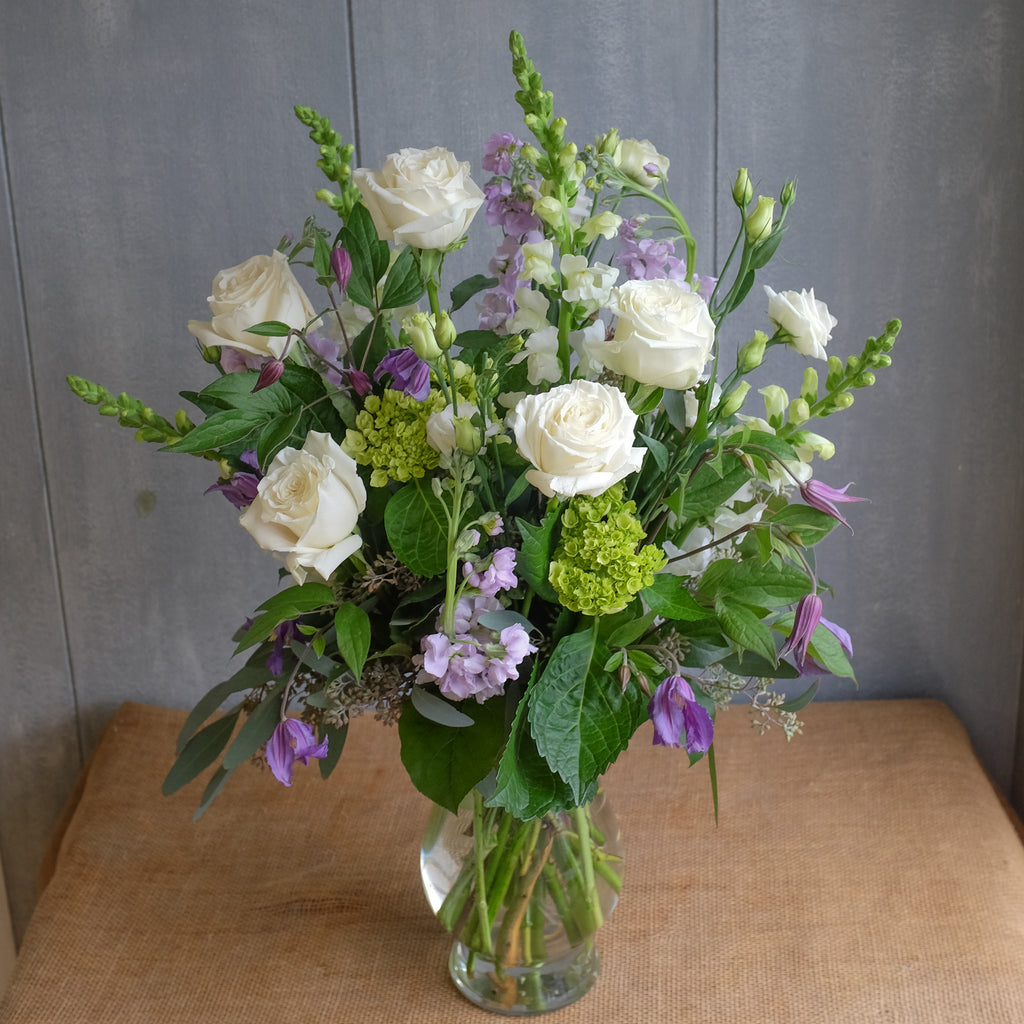White and purple flower bouquet by Michler Florist.